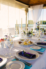 festive table setting for a wedding banquet with purple napkins