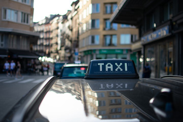 Closeup of Black Taxi sign on a late summer day