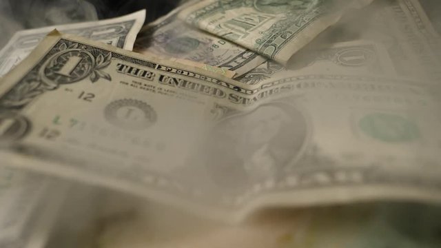 Smoke Over Dollar bills in a box, money background. Dollars money set Slow With Shallow Dof and smoke. Dollars, money close up.