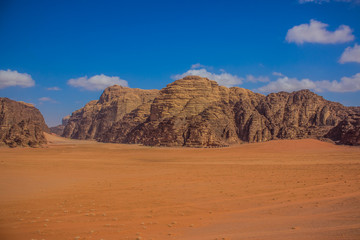 Fototapeta na wymiar picturesque panorama photography of beautiful Wadi Rum desert scenery landscape in Middle East Jordan country with sand valley and mountain ridge background, travel destination place for tour
