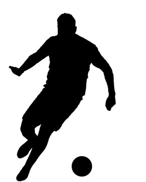 Soccer player as silhouette isolated while shooting a football