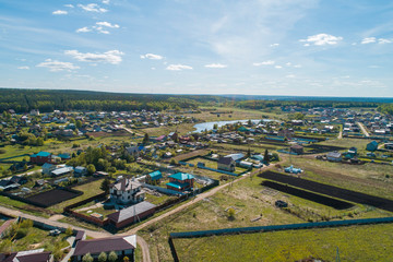 Shaidurovo village with small pond. Summer, sunny day. Aerial