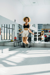 Fototapeta na wymiar sporty woman jumping rope for cardio workout. Motivation
