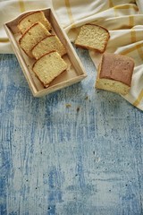 Homemade banana bread slice on a blue background.