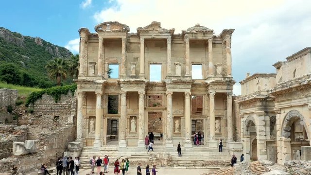 Time lapse of Celsus library in Ephesus ancient city ruins on cloudy sky. Famous place for tourists in Izmir for historical place 4k