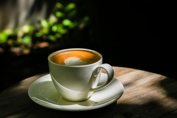 Latte coffee on low light wood floors Natural light for design or background work