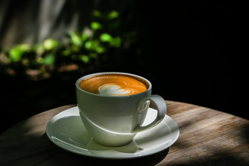 Latte coffee on low light wood floors Natural light for design or background work