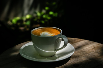 Latte coffee on low light wood floors Natural light for design or background work