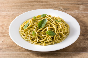 Spaghetti pasta with pesto sauce on wooden table