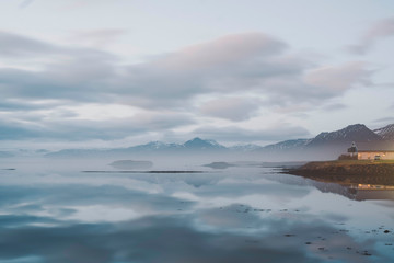 Panoramic view of dramatic landscape with clear lake, a traditional from iceland and amazing mountain in the background