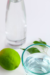Detox Infused Water with  Lime in Glass Bottle on a White Background