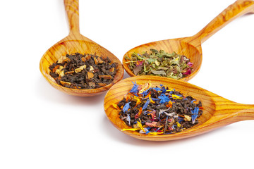 Dried tea on a wooden spoon, isolated on white