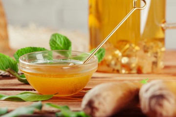 Cup of tea with lemon and honey on wooden background.