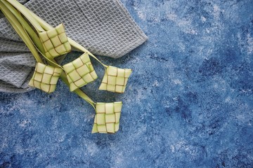 Ketupat (Rice Dumpling) On Blue Background. Ketupat is a natural rice casing made from young coconut leaves for cooking rice during eid Mubarak, Fitri 