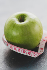 Close-up of apple and tape measure
