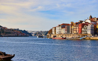 Obraz premium Portugal, Porto old town ribeira aerial promenade view with colorful houses, Douro river and boats.Concept of world travel, sightseeing and tourism