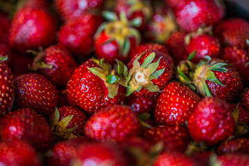 Red ripe strawberries background, selective focus macro shot