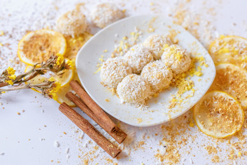 White chocolate truffles with coconut and cinnamon on white background