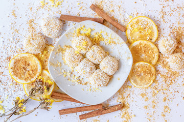 White chocolate truffles with coconut and cinnamon on white background