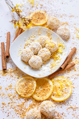 White chocolate truffles with coconut and cinnamon on white background