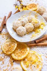 White chocolate truffles with coconut and cinnamon on white background