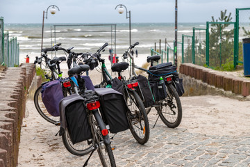 Tourist trekking bikes parked close to the beach and sea.