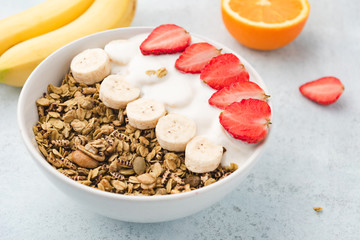 Granola, oatmeal with milk, banana and strawberry