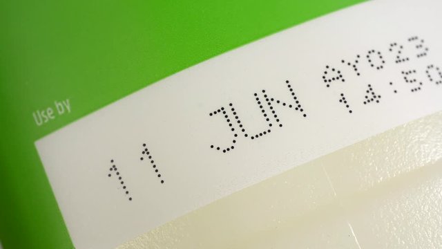 Use by date printed on a fresh milk bottle label. Food and drink safety.