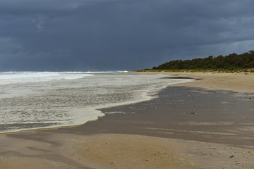 Australian Coastline Pebbly Beach Back Beach Hallidays Point with rain clouds on horizon