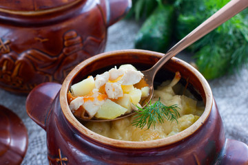 Chicken fillet with potatoes and cheese in clay pots, horizontal