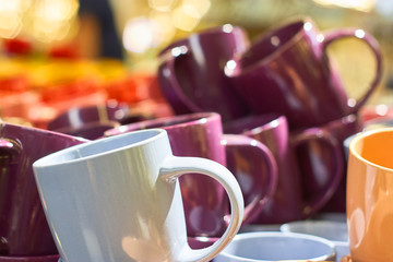 Many colorful empty ceramic cups in store, Mugs background