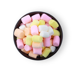 Colorful mini marshmallows n a black cup isolated on white background. Top view.