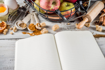 Autumn baking sale concept. Cooking seasonal fall baking background with ingredients, spices, apples, supplies, white wooden table top view copy space