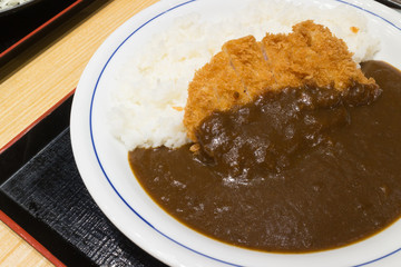 Fried pork Tonkatsu with curry on rice and white dish