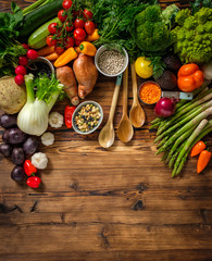 Assortment of fresh vegetables on wooden background