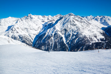 Fototapeta na wymiar Ski resort slope, huge Alp mountains, covered with snow in Tirol, Austria. 