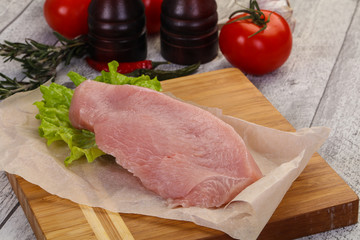 Raw Turkey steak served rosemary