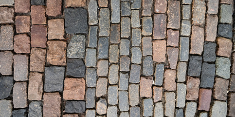 Surface of old colorful square paving stones
