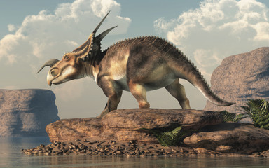An Einiosaurus on boulders by a lake in an arid region. Einiosaurus was a ceratopsian dinosaur, like the triceratops, from the Cretaceous period. 3D Rendering © Daniel Eskridge