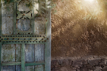 Traditional Moroccan door against clay wall