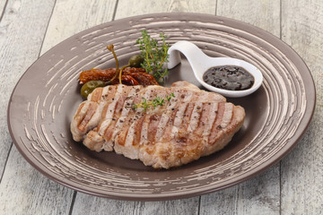 Grilled pork steak with pepper sauce