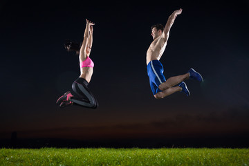 Happy fitness couple jumping