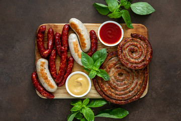 Roasted or grilled sausages served on wooden board