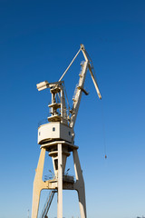 Mobile harbor cranes over blue sky. Transport and technology concept