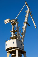 Mobile harbor cranes over blue sky. Transport and technology concept