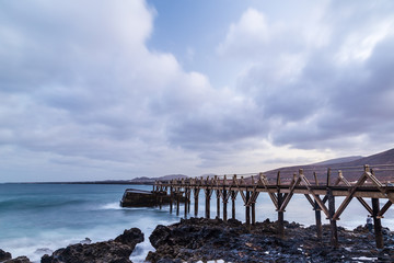 Sunset landscape with bridge on the beach,whit cloudy sky in lanzarote canary islands-.CR2