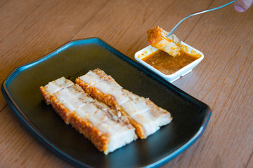 Crispy pork belly or deep fried crispy pork delicious food Chinese cuisine style on wooden table