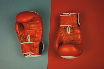 red boxing gloves on a red and blue background.