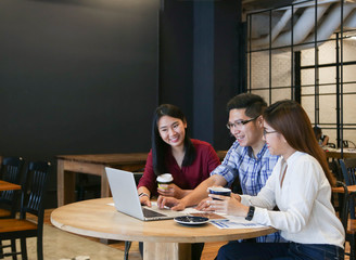 Group of casual Business meeting to discuss ideas and laptop on table in coffee shop.