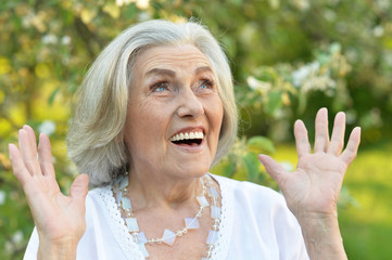 Portrait of senior beautiful woman in spring park